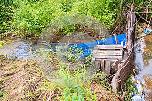 Native Thai fish trap made from weaved bamboo with blue nylon ne