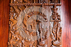 Native Thai style carving, painting on church door in the temple