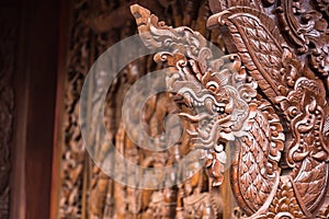 Native Thai style carving, painting on church door in the temple