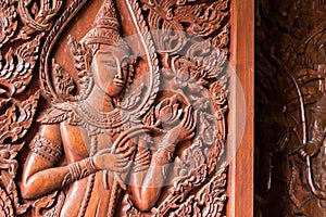 Native Thai style carving, painting on church door in the temple