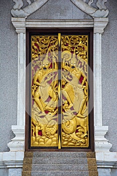 Native Thai style carving, painting on church door in Thai temple