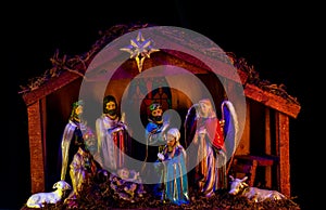 Nativity of Jesus. Christmas Manger scene with figures of Jesus, Mary, Joseph, sheep and magi.