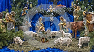 Christmas nativity scene with baby Jesus, Mary and Joseph in the manger with sheeps. Christmas event