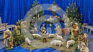 Christmas nativity scene with baby Jesus, Mary and Joseph in the manger with sheeps. Christmas event