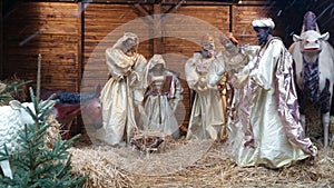 Nativity scene crÃÂ¨che with life size figures in stable with straw