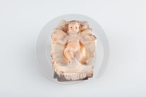 Nativity scene figurine of baby jesus with white background