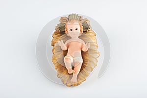 Nativity scene figurine of baby jesus with white background