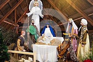 Nativity scene with Holy Family: baby Jesus, Blessed Virgin Mary, Saint Joseph, angel and three wise men and sheep. Nativity.