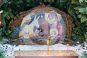 Nativity scene near the church with figures in the form of Jesus, Mary, Joseph
