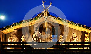 Nativity scene on a wooden house at the Christmas market