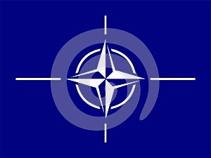 NATO flag. rectangular horizontal blue banner with a white four-pointed star wind rose and diverging white lines.