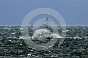 NATO military ship at sea during a storm