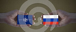 Nato and russia flag hold in hands- concept for ukraine invasion, war, cold war, putin war