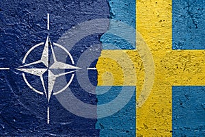 NATO and Sweden - Cracked concrete wall painted with a OTAN flag on the left and a Swedish flag on the right stock photo