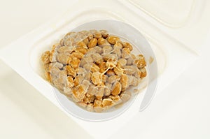 Natto, fermented soybeans on white background.