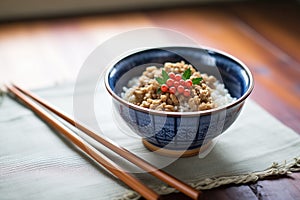 natto fermented soybeans in a wooden bowl with chopsticks
