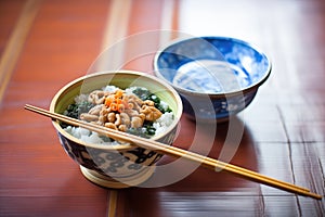 natto fermented soybeans in a wooden bowl with chopsticks