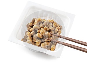 Natto packets and chopsticks on a white background
