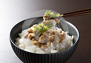 Natto and rice set against a dark wooden background