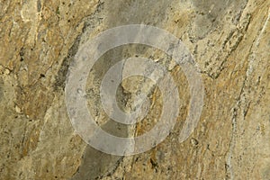 Natural abstract background. The texture of the old yellow stone wall with chinks