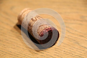 a natural wine cork with little cork bleed of red wine photo
