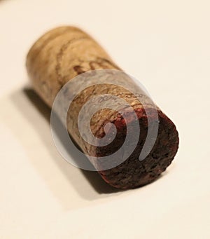 a natural wine cork with little cork bleed of red wine photo