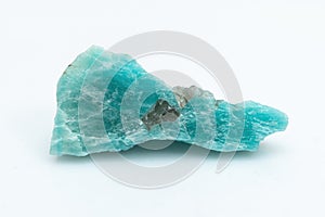 Natural amazonite gemstone isolated on white background. A bluish-green crystal on a white background. A variety of