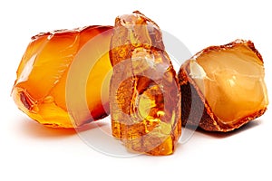 Natural amber. Pieces of yellow opaque natural amber on white background.