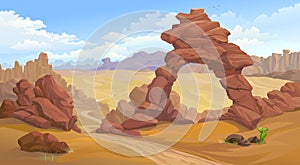 A natural arc formation in the middle of a desert. A road passing towards canyon.