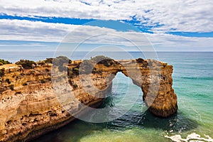 Natural arch above ocean, Arco de Albandeira, Algarve, Portugal. Stone arch at Praia de Albandeira, Lagoa, Algarve, Portugal. View photo