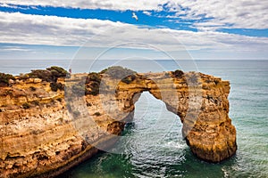 Natural arch above ocean, Arco de Albandeira, Algarve, Portugal. Stone arch at Praia de Albandeira, Lagoa, Algarve, Portugal. View photo