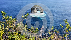 Natural arch from Banah Cliff viewpoint on Nusa Penida Island, Bali, Indonesia