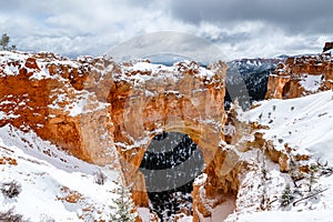 Natural Arch formation with snow in Bryce Canyon.