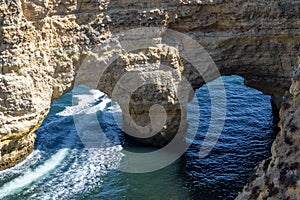 Natural Arch of Marinha Beach during low tide. Landmark in Lagoa, Algarve