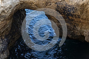 Natural Arch of Marinha Beach during low tide. Landmark in Lagoa, Algarve