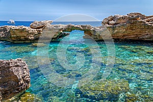 Natural arch in a rocky cliff in the National Park of the Gulf of Orosei, Sardinia, Italy.