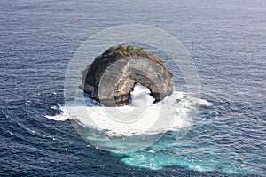 Natural arch seen from Banah Cliff viewpoint on Nusa Penida Island, Bali, Indonesia