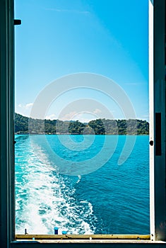 The natural background in the boat windows of indigo water as the ferry sailed into the ocean.