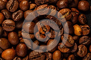 Natural background for Cafe menu or brochure template - macro photo of brown roasted coffee beans, close up