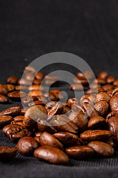 Natural background for Cafe menu or brochure template - macro photo of brown roasted coffee beans, close up