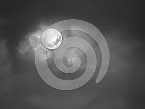Natural background with full moon and stormy clouds in black and white