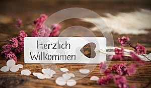 Natural Background With Label With Herzlich Willkommen