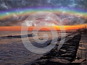 Natural background with mediterranean sea and rainbow in the sunset