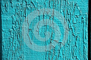 Natural background old wood texture, uneven painted blue, turquoise peeling paint