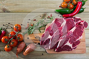 Natural background with raw beef, vegetables