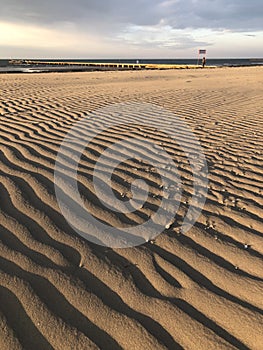 Natural background: Ribbed sand in early morning light on Grado beach