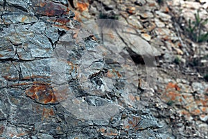 Natural basalt rock with cracks and crevices with a red color coming from iron