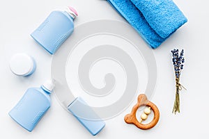 Natural bath cosmetics for kids. Bottles, towel and toys on white background top view copyspace