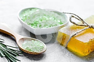 natural bath salt with rosemary on stone table background