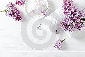 Natural bath salt, soap, cotton towels and lilac flowers symbolic image